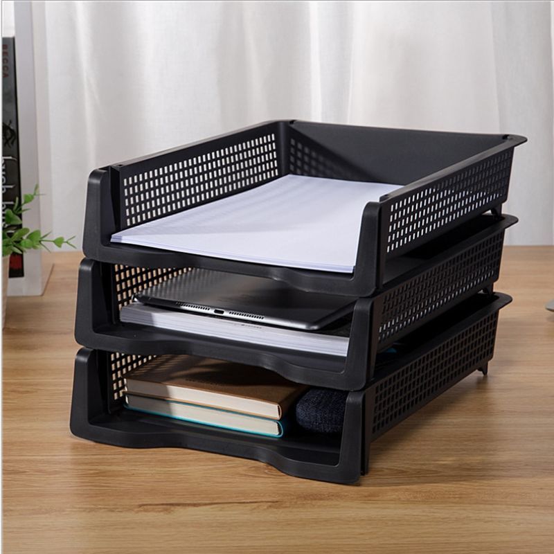 Paper invoices stacked in office filing trays